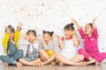 Happy Asian group of kids having fun during birthday party with confetti Royalty Free Stock Photo