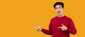 Happy asian guy pointing fingers at free space, panorama Royalty Free Stock Photo