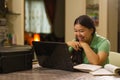 Happy Asian high school girl laughing at laptop Royalty Free Stock Photo