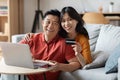 Happy asian husband and wife booking hotel online Royalty Free Stock Photo