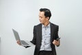 happy asian indonesian business man in suit holding smart phone and laptop computer on isolated background Royalty Free Stock Photo