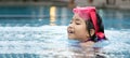 Happy asian kid big smile to playing swim in water pool Royalty Free Stock Photo