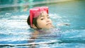 Happy asian kid big smile to playing swim in water pool Royalty Free Stock Photo