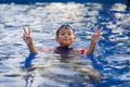 Happy asian kid boy swiming on swiming pool in the summer Royalty Free Stock Photo