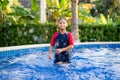 Happy asian kid boy swiming on swiming pool in the summer Royalty Free Stock Photo