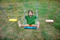 Happy asian kid play swing outdoor playpark