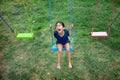 Happy asian kid play swing outdoor playpark