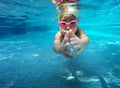 Happy asian kid swimming underwater in summer. Royalty Free Stock Photo