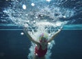 Happy asian kid swimming underwater in summer. Royalty Free Stock Photo