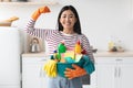 Happy asian lady with cleaning tools showing muscle strength