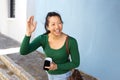 Happy asian lady outdoors on street gesturing for a taxi Royalty Free Stock Photo