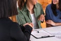 Happy asian lesbian couple handshake for buy new house with realtor agent at new home after marry.LGBTQ lifestyle concep