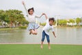 Happy Asian little boy and girl child jumping together in the garden Royalty Free Stock Photo