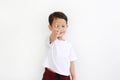 Happy Asian little boy holding lollipop candy against white background. Focus at colorful candy rod in his hand Royalty Free Stock Photo