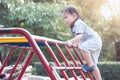 Happy asian little child boy having fun to play and climb up