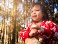 Happy Asian little child girl gone camping at pine forest with family on winter seasons. The concept of outdoor activities and