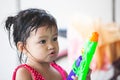 Asian little child girl having fun to play water with water gun in Songkran festival Thailand Royalty Free Stock Photo
