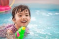 Happy asian little child girl having fun to play water gun Royalty Free Stock Photo