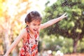 Happy asian little child girl having fun to play water in summer Royalty Free Stock Photo