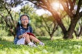 Happy asian little child girl reading book in the garden Royalty Free Stock Photo