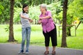 Happy asian little child girl smiling and exercise with elderly woman in outdoor park,granddaughter,senior grandmother dancing, Royalty Free Stock Photo