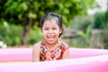 Happy asian little child girl smiling and fun to play water Royalty Free Stock Photo
