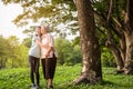 Happy asian little child girl support,hugging senior grandmother,smiling granddaughter in outdoor park,elderly woman with walking Royalty Free Stock Photo