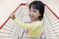 Happy Asian Little Chinese Girl sitting in shopping cart Royalty Free Stock Photo