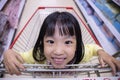 Happy Asian Little Chinese Girl sitting in shopping cart Royalty Free Stock Photo