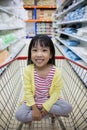 Happy Asian Little Chinese Girl sitting in shopping cart Royalty Free Stock Photo