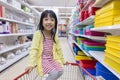 Happy Asian Little Chinese Girl sitting in shopping cart Royalty Free Stock Photo