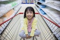 Happy Asian Little Chinese Girl sitting in shopping cart Royalty Free Stock Photo