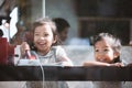 Happy asian little girl playing and talking phone in cafe Royalty Free Stock Photo