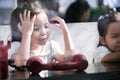 Happy asian little girl playing and talking phone in cafe Royalty Free Stock Photo