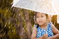 Happy asian little girl with umbrella in rain Royalty Free Stock Photo