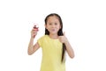 Happy asian little kid girl eating ice cream cone isolated on white background Royalty Free Stock Photo