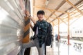 A happy Asian man backpacker is getting on the train, travel somewhere on his summer vacation Royalty Free Stock Photo