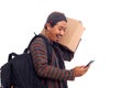 Happy Asian man carrying a cardboard box while holding a cellular phone.Isolated on white background