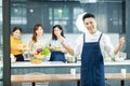 Happy asian man chef and woman cooking together in kitchen Royalty Free Stock Photo