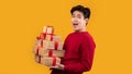 Happy asian man holding stack of present boxes Royalty Free Stock Photo