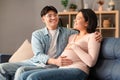 Happy asian man hugging pregnant wife touching belly at home Royalty Free Stock Photo