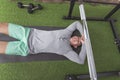 A happy asian man lies down on the mat and relaxing after a satisfying workout. Feeling the pump and high on endorphins. At a home