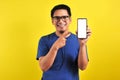 Happy Asian man showing a phone screen and pointing Royalty Free Stock Photo