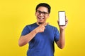 Happy Asian man showing a phone screen and pointing