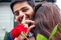 Happy asian man in stylish black suit falling knee in front of his beautiful woman in blue long dress asking proposal Royalty Free Stock Photo