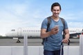 Happy asian man traveler standing with bag and mobile phone Royalty Free Stock Photo