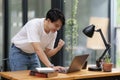 Happy Asian man using laptop computer while have a good news working at office Royalty Free Stock Photo