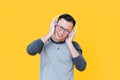 Happy Asian man wearing headphones listening to relaxing music Royalty Free Stock Photo