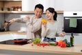 Happy asian man and woman cooking together at home Royalty Free Stock Photo