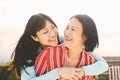 Happy Asian mother and daughter having fun outdoor - Chinese family people spending time together outside Royalty Free Stock Photo